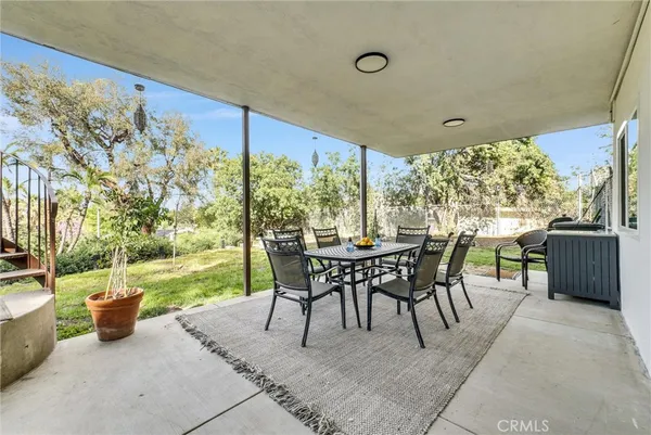 a view of a patio with a dining table and chairs