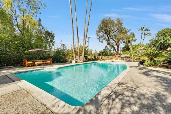 a view of a swimming pool with a yard