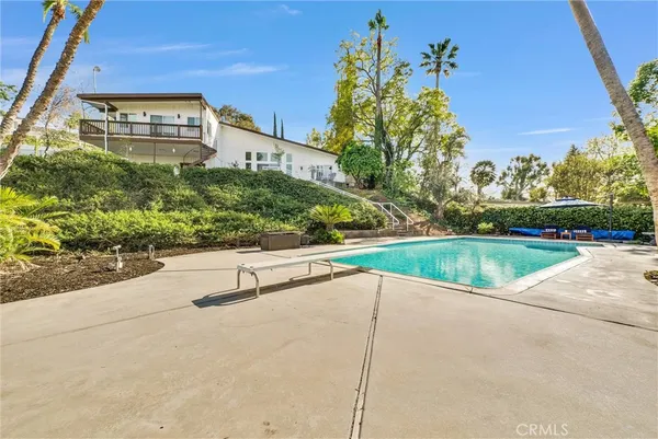a view of a swimming pool with a yard