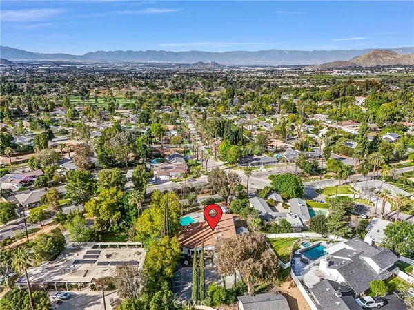 an aerial view of residential building with parking and yard