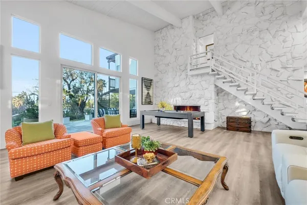 a living room with furniture fireplace and a table
