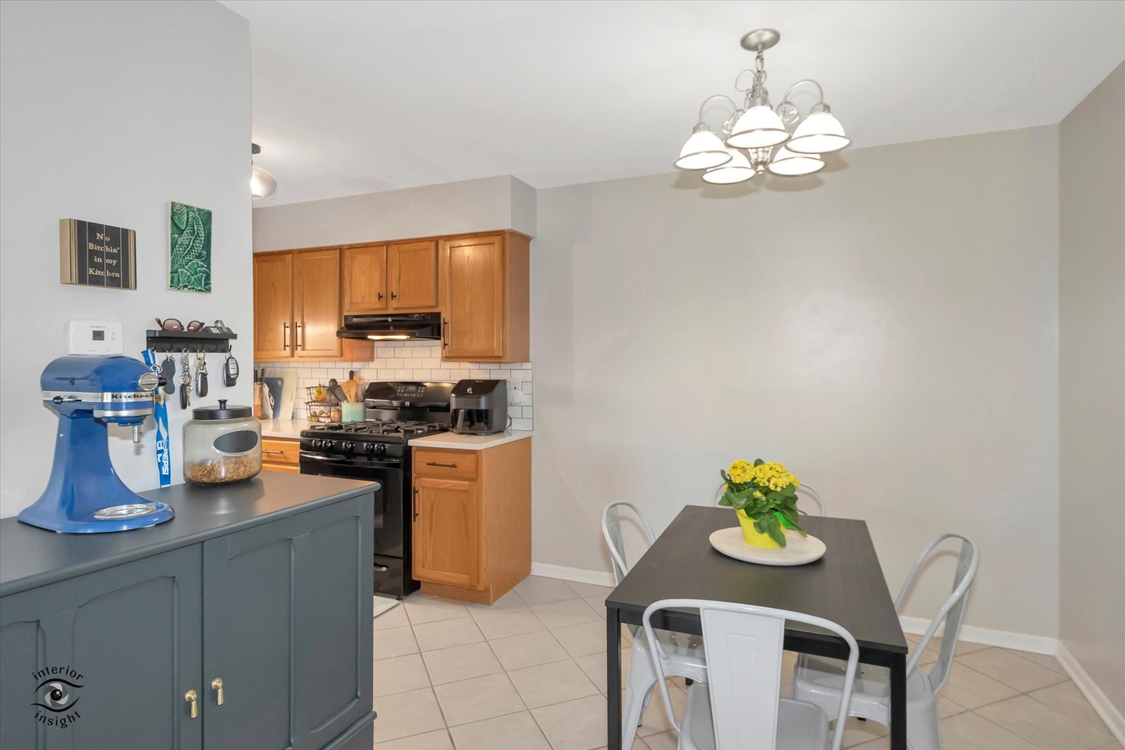 19300 Wolf Road, Unit 10 Mokena, IL 60448 - Photo 8 of 22 a kitchen with a sink dining table and chairs