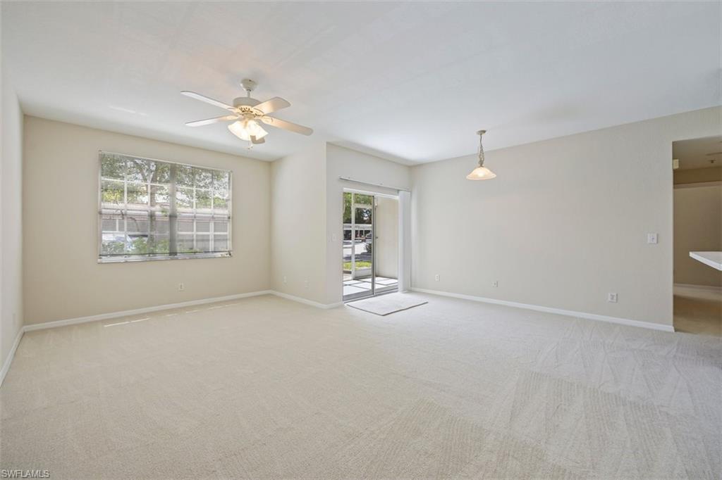 4635 St Croix Lane, Unit 1218 Naples, FL 34109 - Photo 6 of 40 Unfurnished room featuring a ceiling fan and light carpet