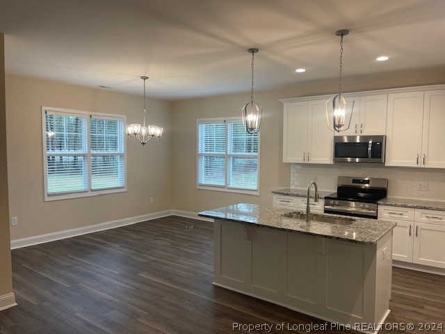 179 Rocking Canal Place Erwin, NC 28339 - Photo 5 of 17 a kitchen with stainless steel appliances granite countertop a sink a stove and a wooden floors