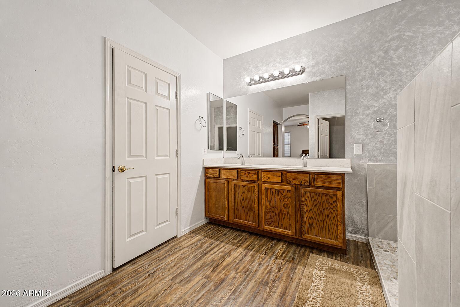 6622 West Harwell Road Laveen, AZ 85339 - Photo 18 of 32 a bathroom with a sink mirror and vanity