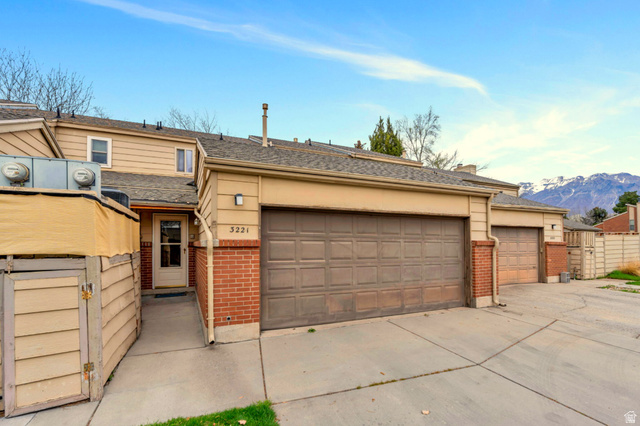3221 North Shadowbrook Circle Provo, UT 84604 - Photo 28 of 29 Front exterior featuring a two-car garage, brick accents, and a paved driveway