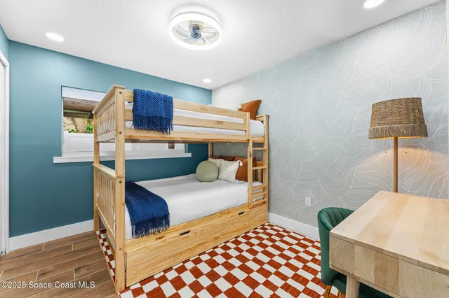 a bedroom with a bed and a desk