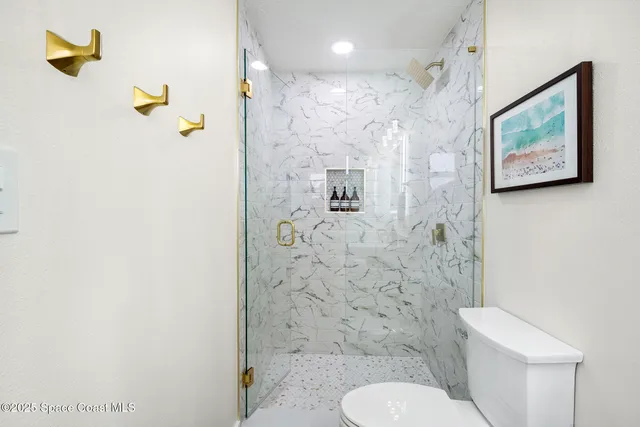 a bathroom with a toilet sink and shower