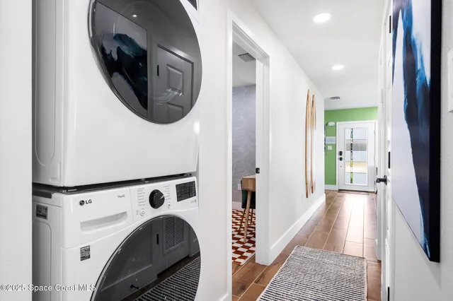 a view of a hallway with washer and dryer