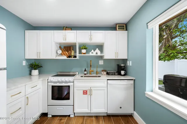 a view of a kitchen with furniture and wooden floor
