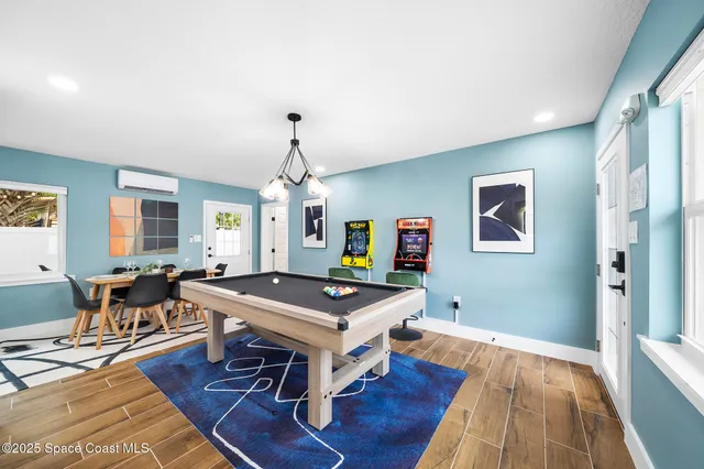 a living room with dining table and a wooden floor