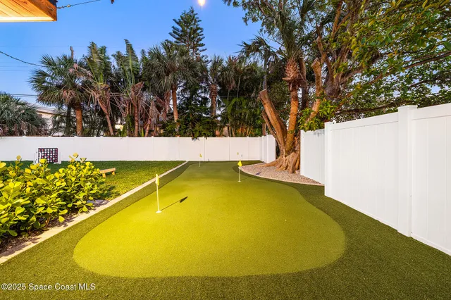 a view of a swimming pool with an outdoor seating and a yard