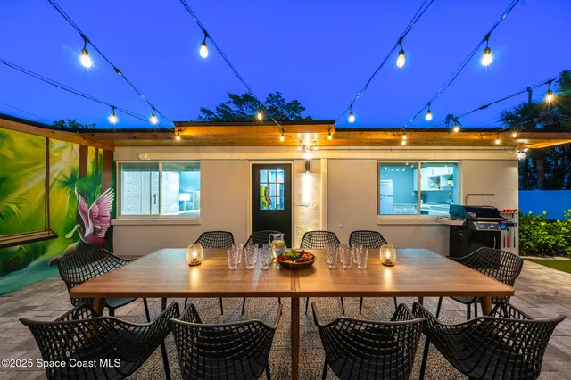 a front view of a house with yard glass table and chairs