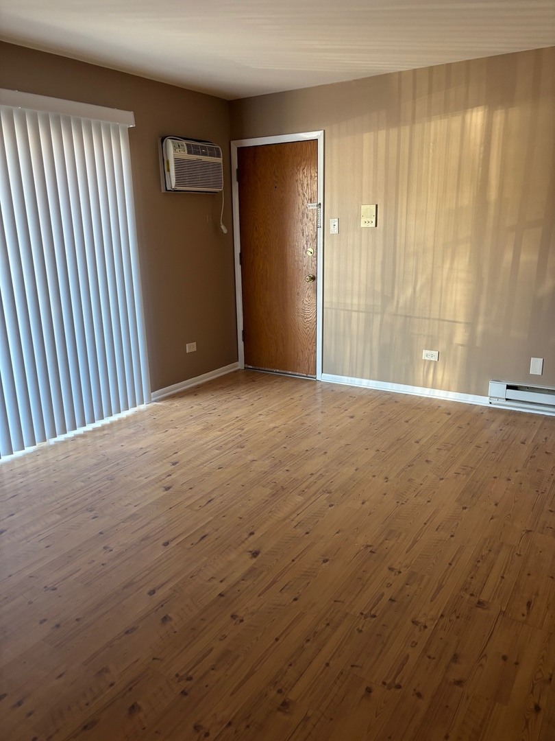 6323 West 64th Place, Unit 1D Chicago, IL 60638 - Photo 2 of 16 an empty room with windows