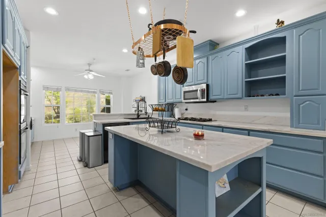 a kitchen with a sink dishwasher and a stove with wooden cabinets