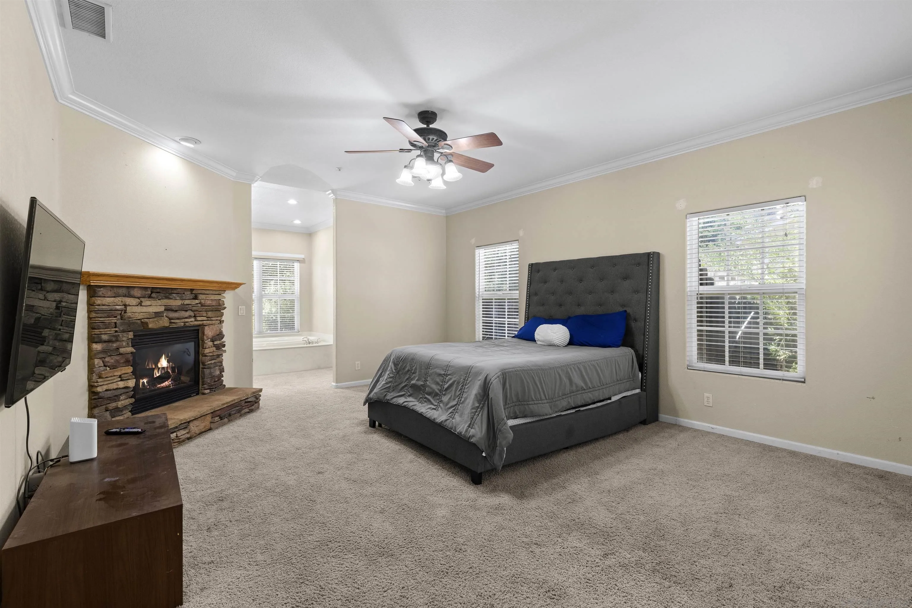 24849 Pappas Road Ramona, CA 92065 - Photo 15 of 50 a spacious bedroom with a bed and a fireplace
