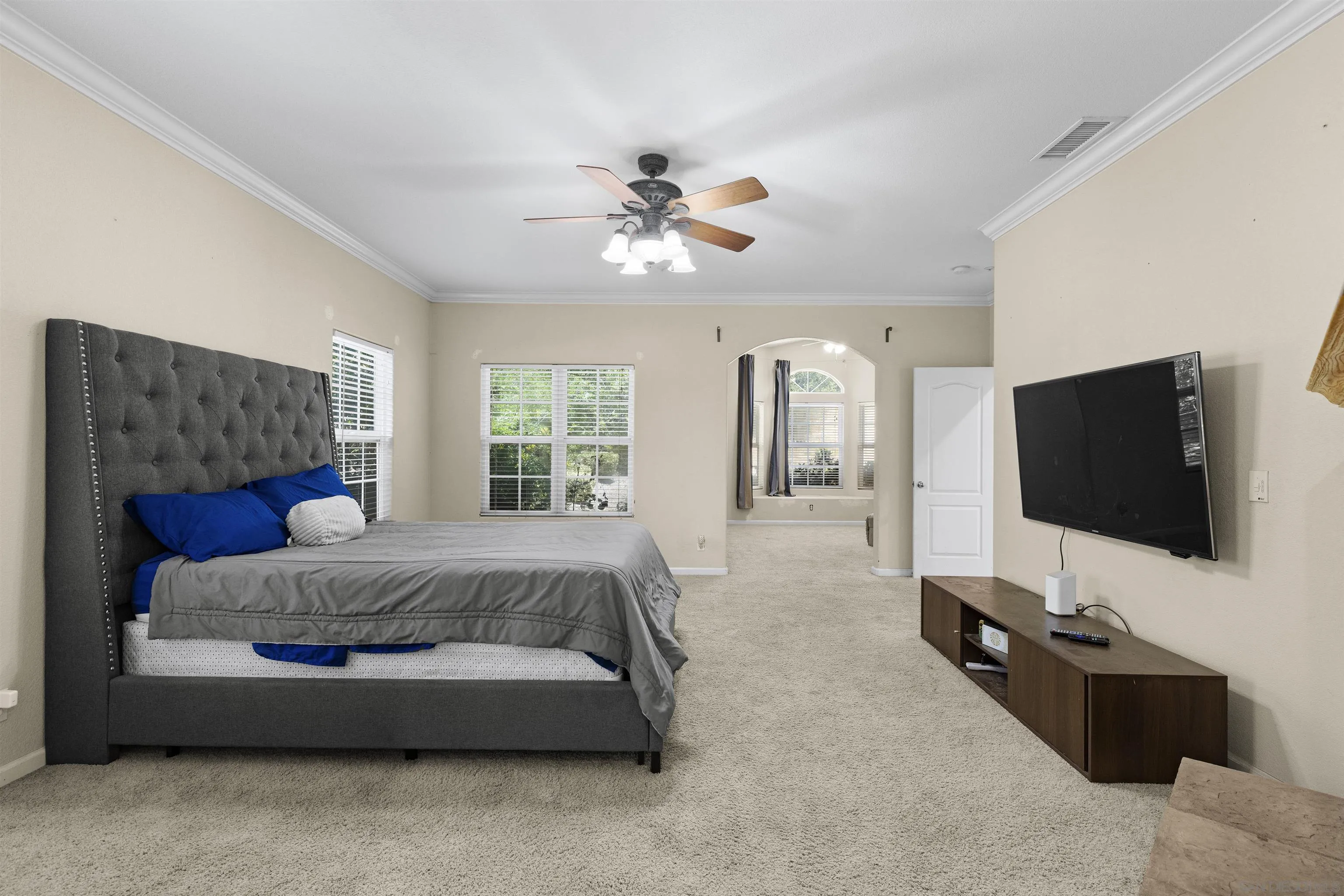 24849 Pappas Road Ramona, CA 92065 - Photo 16 of 50 a spacious bedroom with a bed and a flat screen television