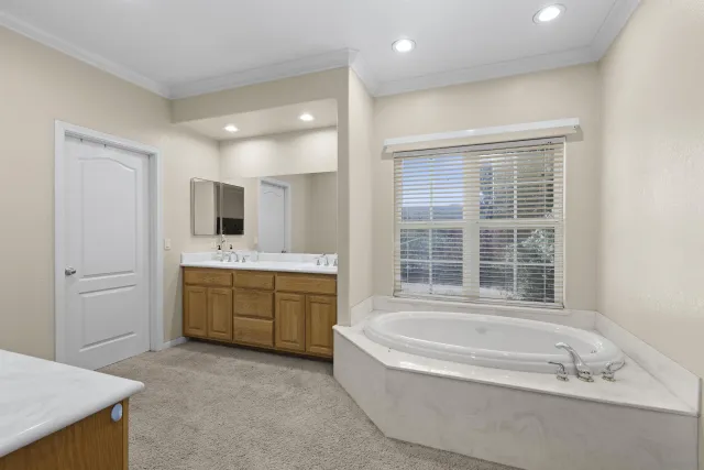 a spacious bathroom with sink shower bathtub and mirror
