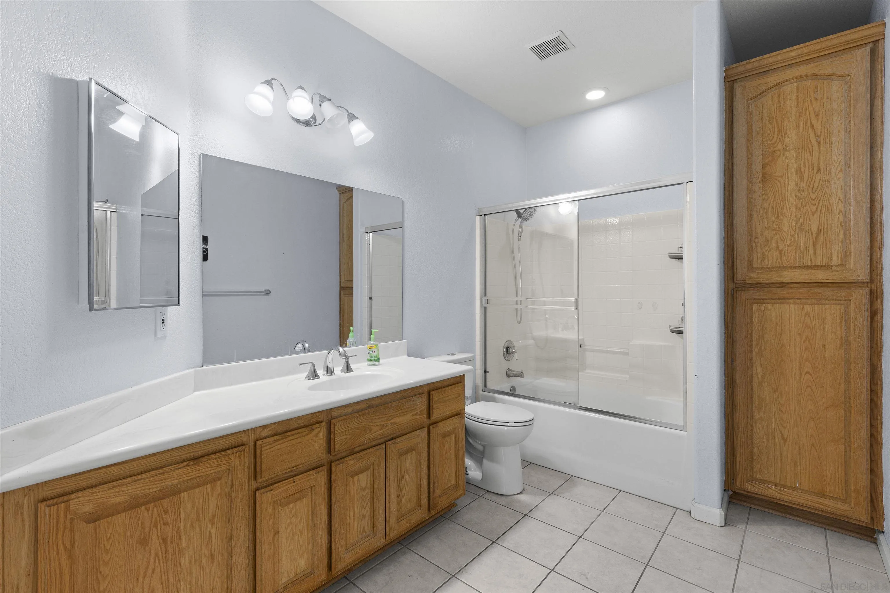 24849 Pappas Road Ramona, CA 92065 - Photo 24 of 50 a bathroom with a sink toilet double vanity and tub