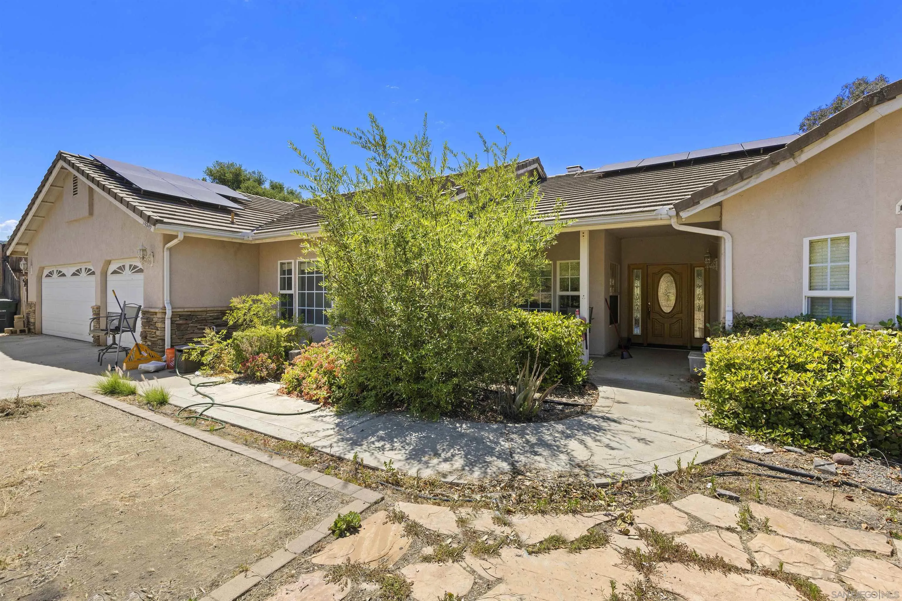24849 Pappas Road Ramona, CA 92065 - Photo 3 of 50 a front view of a house with garden