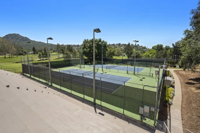 a view of a balcony with furniture and a garden