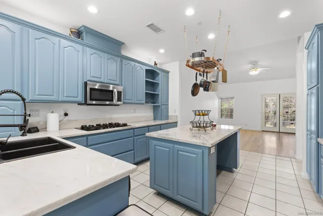 a kitchen with stainless steel appliances a stove sink microwave and cabinets