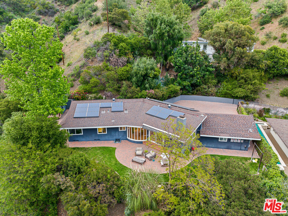 3940 Mandeville Canyon Road Los Angeles, CA 90049 - Photo 1 of 54 an aerial view of a house with garden space and a view of a house