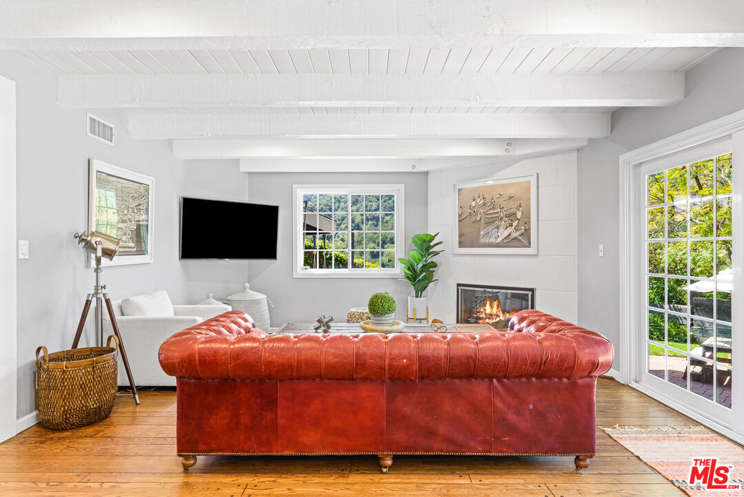3940 Mandeville Canyon Road Los Angeles, CA 90049 - Photo 11 of 54 a bedroom with a bed window and flat screen tv