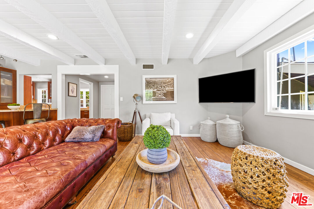 3940 Mandeville Canyon Road Los Angeles, CA 90049 - Photo 12 of 54 a living room with furniture and a flat screen tv