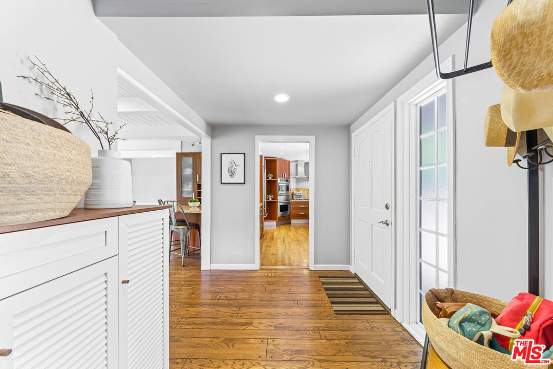 3940 Mandeville Canyon Road Los Angeles, CA 90049 - Photo 13 of 54 a view of a hallway to closet and wooden floor