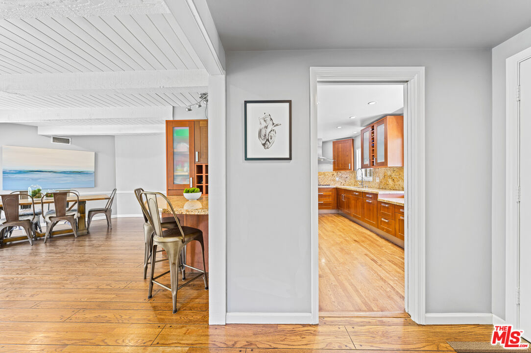 3940 Mandeville Canyon Road Los Angeles, CA 90049 - Photo 14 of 54 a dining room with furniture and wooden floor