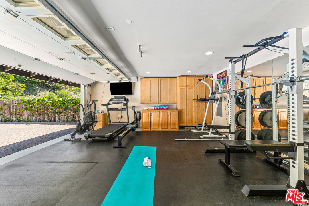 3940 Mandeville Canyon Road Los Angeles, CA 90049 - Photo 22 of 54 a view of a room with gym equipment