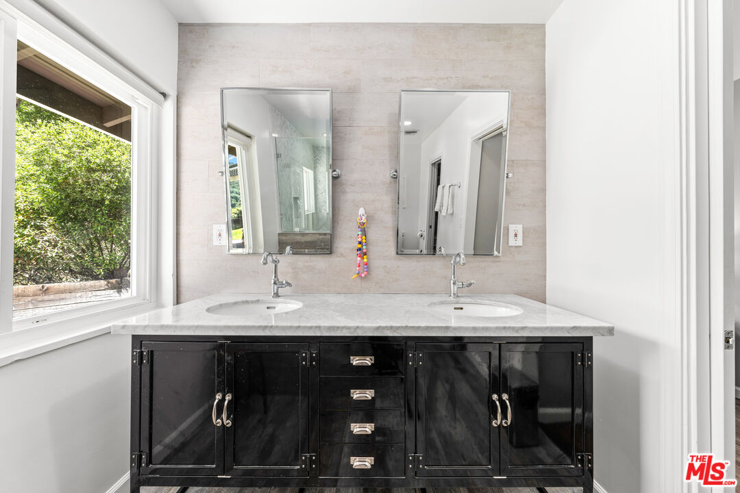 3940 Mandeville Canyon Road Los Angeles, CA 90049 - Photo 27 of 54 a bathroom with a sink and a mirror