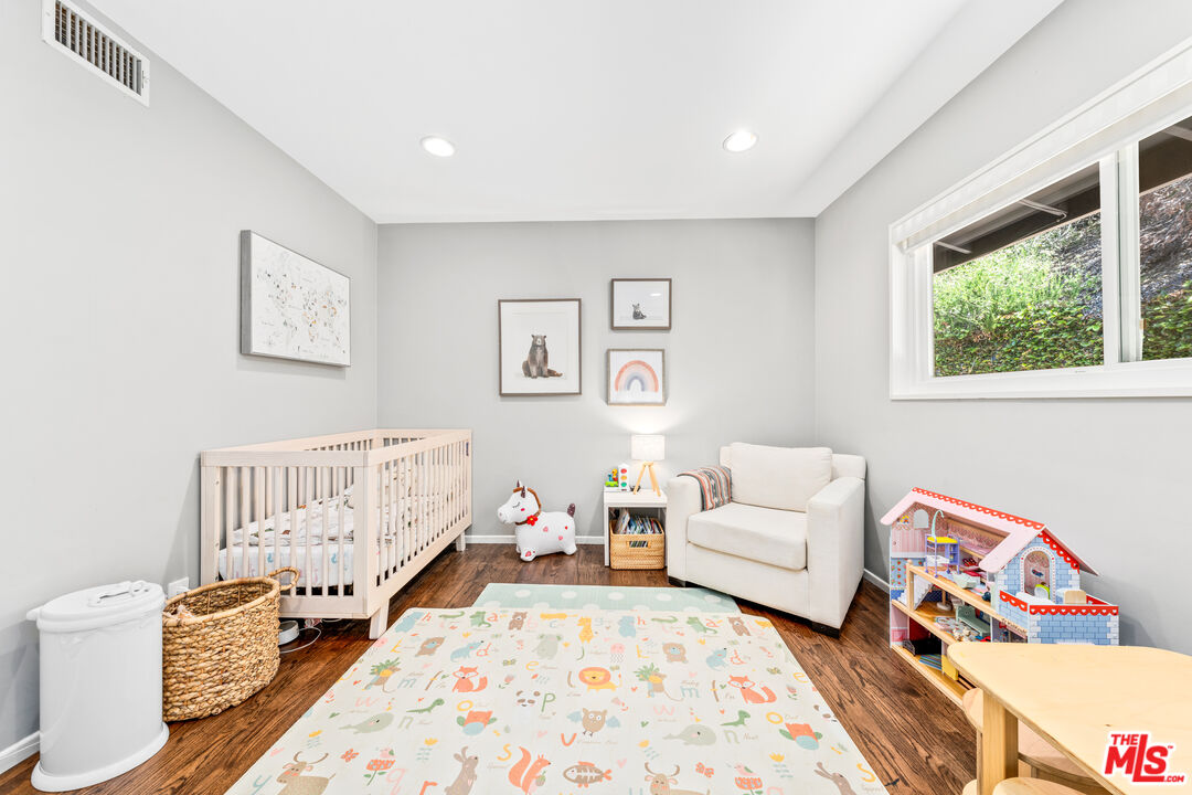 3940 Mandeville Canyon Road Los Angeles, CA 90049 - Photo 31 of 54 a bedroom with furniture and a window