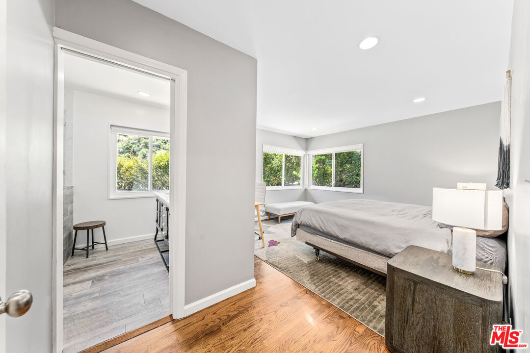 3940 Mandeville Canyon Road Los Angeles, CA 90049 - Photo 34 of 54 a spacious bedroom with a bed and a window