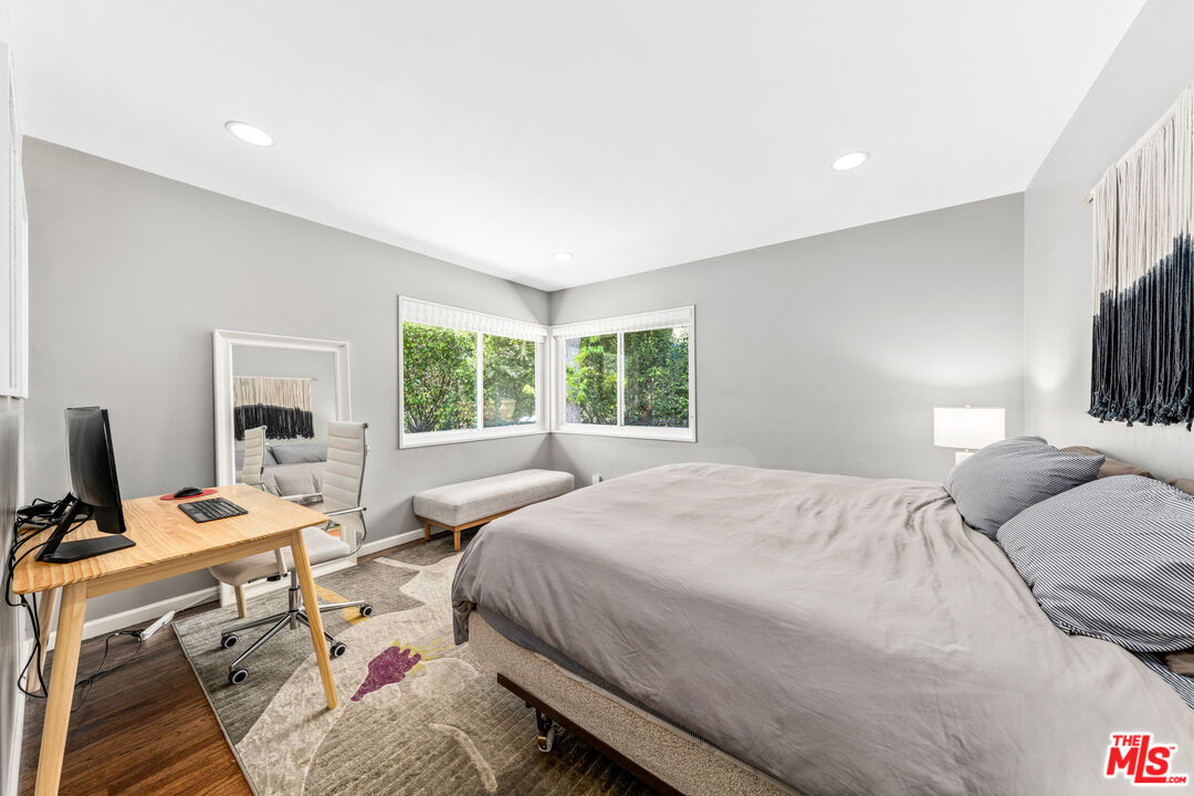 3940 Mandeville Canyon Road Los Angeles, CA 90049 - Photo 35 of 54 a bedroom with a bed a computer on the desk and a window