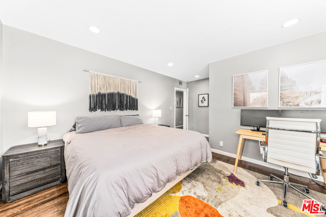 3940 Mandeville Canyon Road Los Angeles, CA 90049 - Photo 37 of 54 a bedroom with a bed and wooden floor