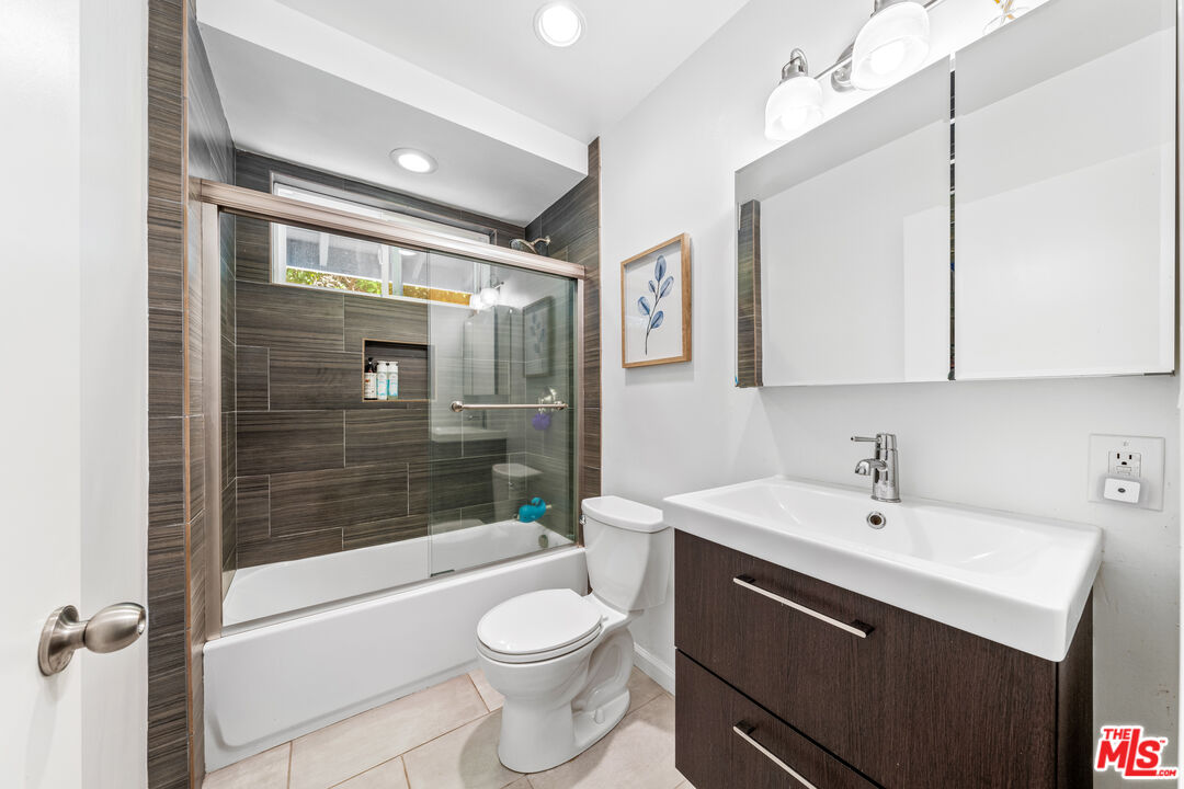 3940 Mandeville Canyon Road Los Angeles, CA 90049 - Photo 38 of 54 a bathroom with a sink a toilet and shower