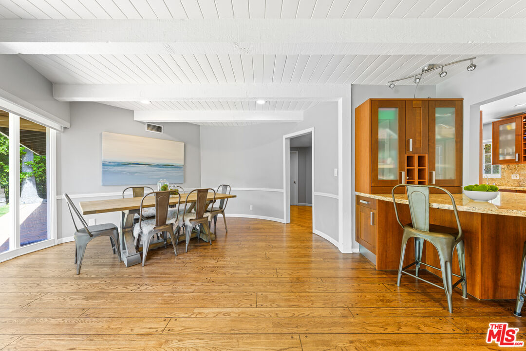 3940 Mandeville Canyon Road Los Angeles, CA 90049 - Photo 39 of 54 a view of a dining room with furniture and wooden floor