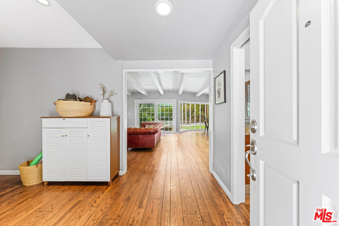 3940 Mandeville Canyon Road Los Angeles, CA 90049 - Photo 4 of 54 a bed room with a bed and a large window