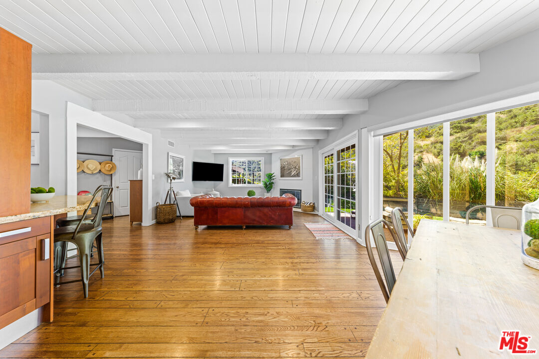 3940 Mandeville Canyon Road Los Angeles, CA 90049 - Photo 41 of 54 a living room with furniture and a fireplace