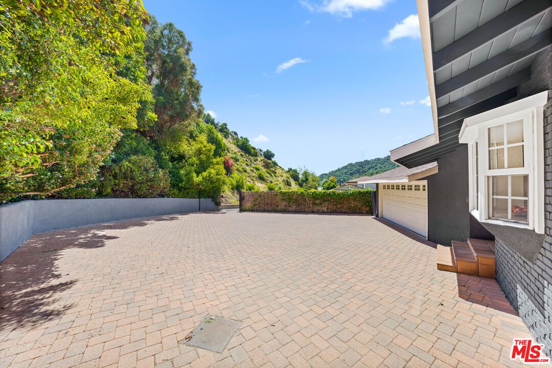 3940 Mandeville Canyon Road Los Angeles, CA 90049 - Photo 45 of 54 a view of an outdoor space and a balcony