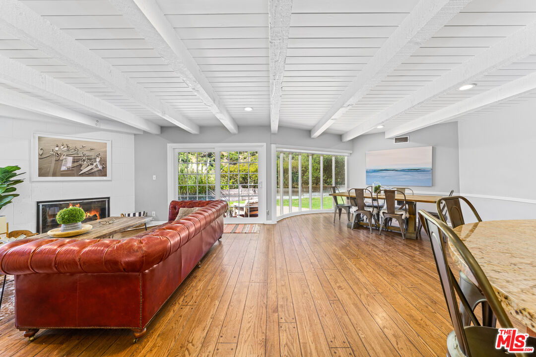 3940 Mandeville Canyon Road Los Angeles, CA 90049 - Photo 5 of 54 a bedroom with furniture and large windows