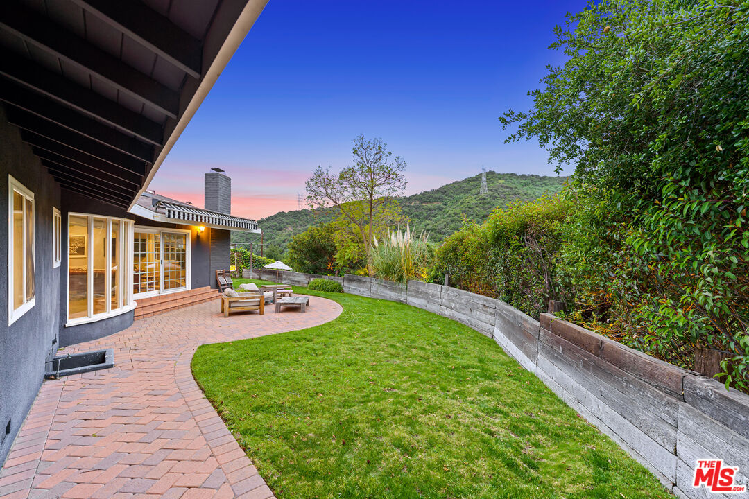 3940 Mandeville Canyon Road Los Angeles, CA 90049 - Photo 53 of 54 a view of a backyard with sitting area