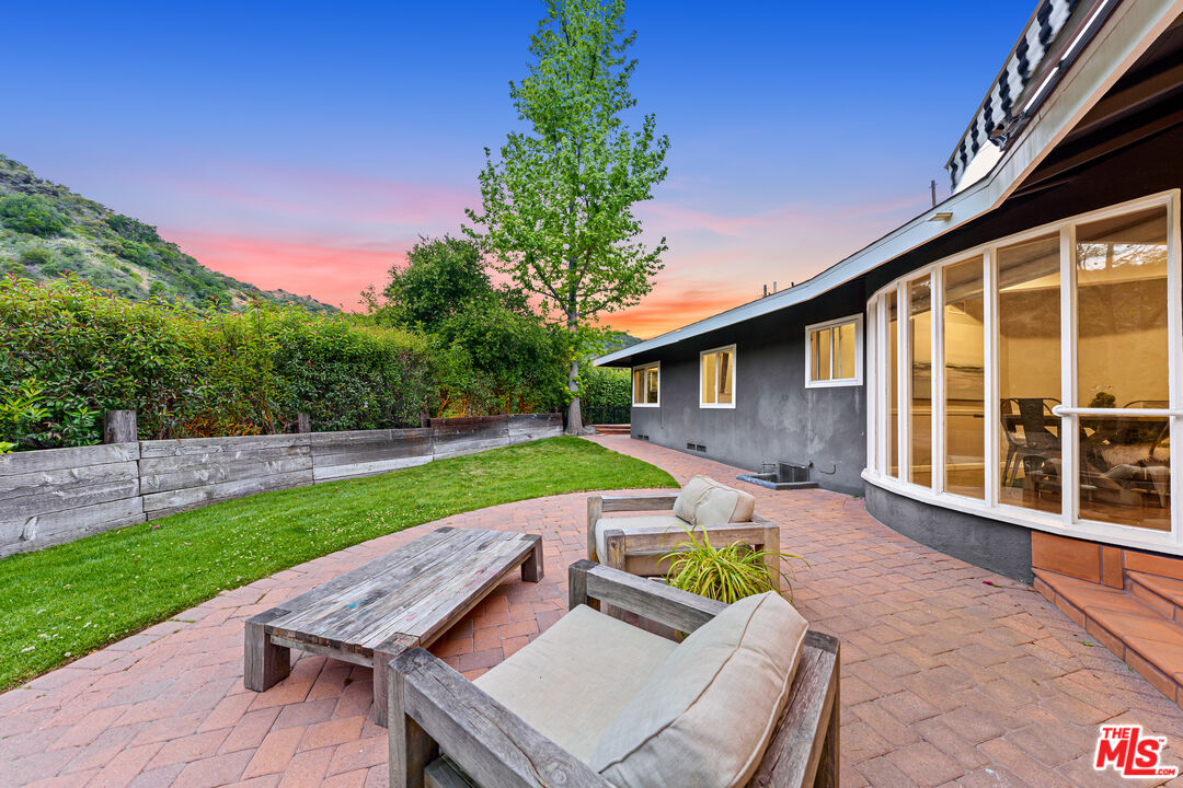 3940 Mandeville Canyon Road Los Angeles, CA 90049 - Photo 54 of 54 a view of house with backyard and outdoor seating