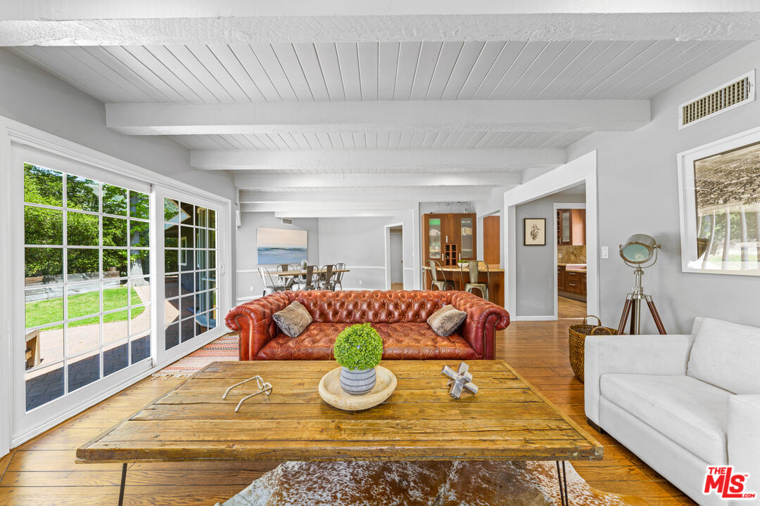 3940 Mandeville Canyon Road Los Angeles, CA 90049 - Photo 6 of 54 a living room with furniture and a large window