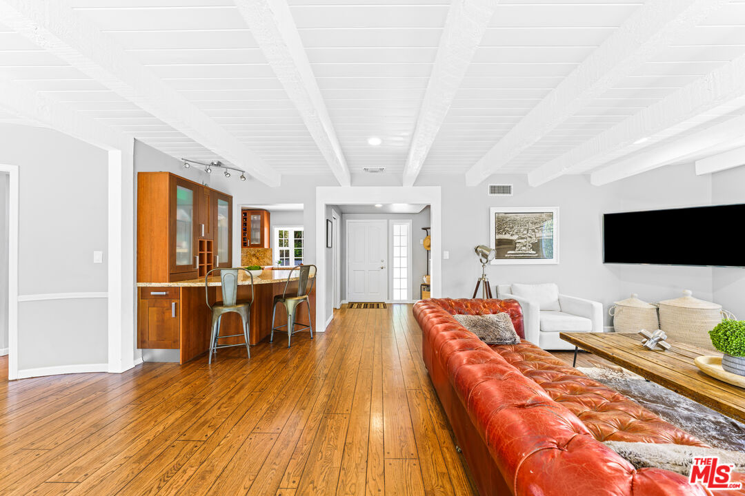3940 Mandeville Canyon Road Los Angeles, CA 90049 - Photo 7 of 54 a living room with furniture and a flat screen tv