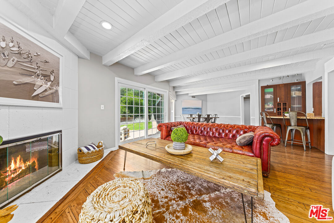 3940 Mandeville Canyon Road Los Angeles, CA 90049 - Photo 9 of 54 a living room with furniture fireplace and window