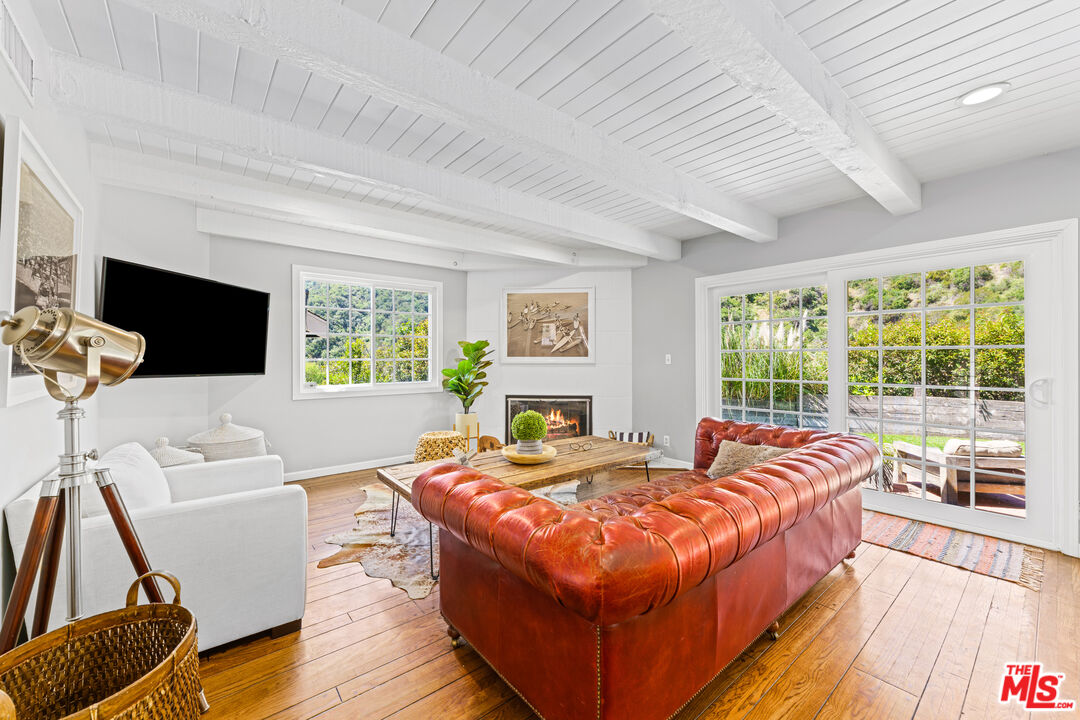3940 Mandeville Canyon Road Los Angeles, CA 90049 - Photo 10 of 54 a bed sitting in a bedroom next to a window