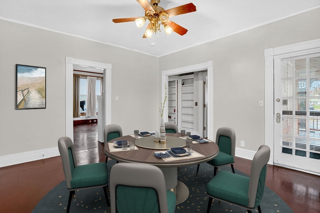55 Florida Street Springfield, MA 01109 - Photo 12 of 42 a dining room with furniture a rug and a chandelier
